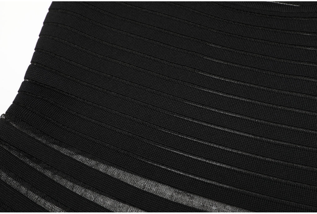 Midsection detail of black striped knit dress showing stripes