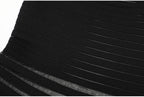 Midsection detail of black striped knit dress showing stripes
