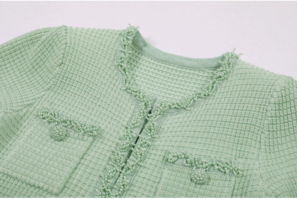 Pocket and neckline pearl embellishment detail on mint green dress
