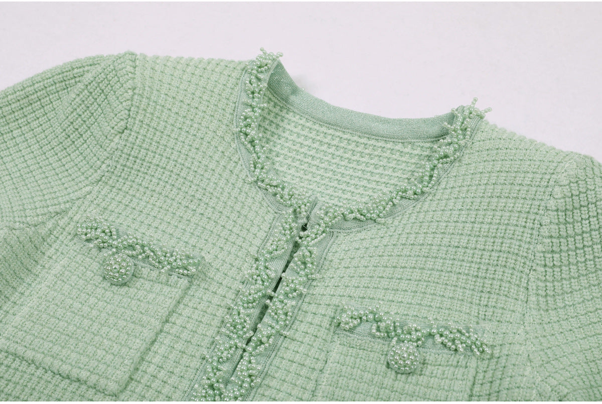 Pocket and neckline pearl embellishment detail on mint green dress