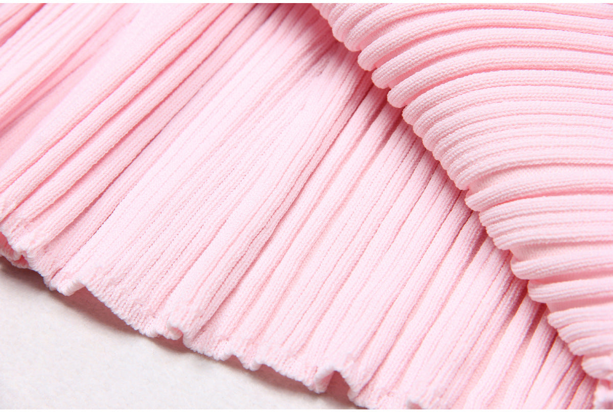 Close-up of pleated knit dress fabric texture in pink