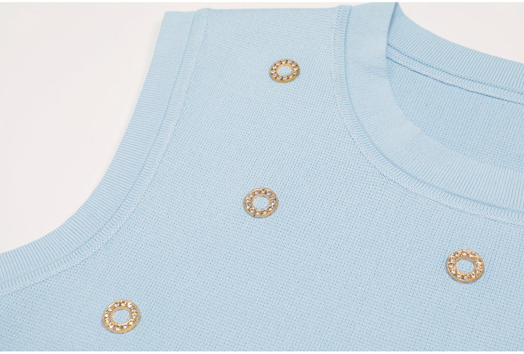 Side view accentuating ribbed knit and crystals on blue tank top