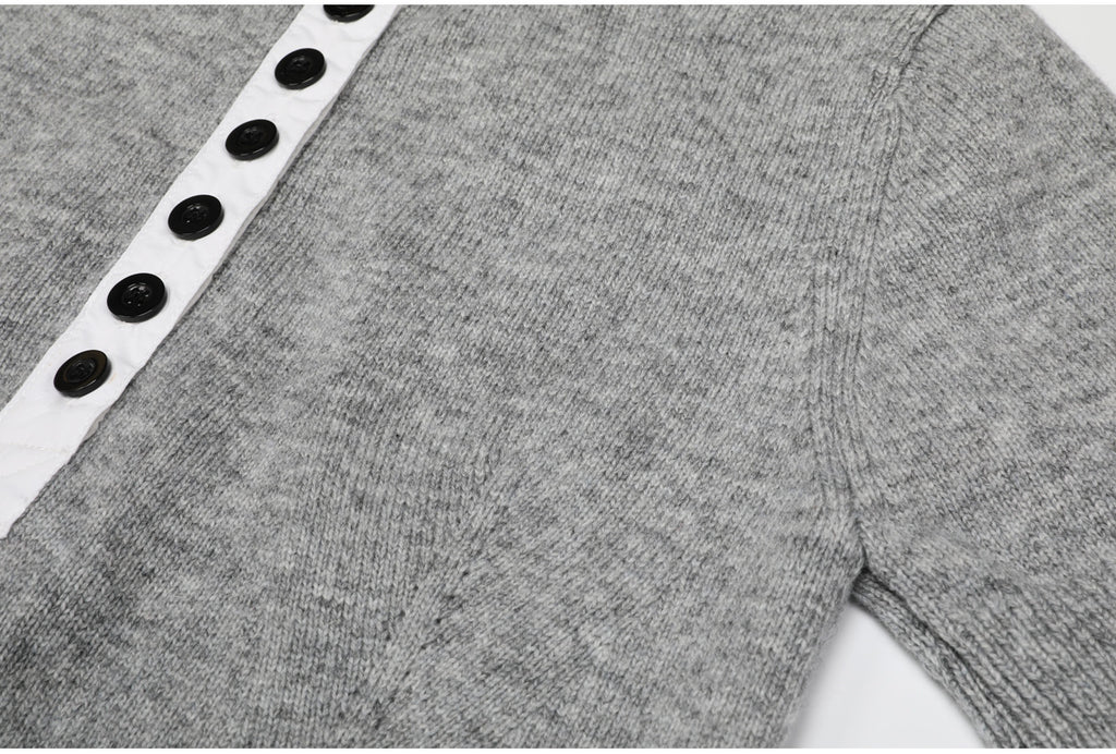 Gray knit top button placket and sleeve seam detail