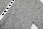 Gray knit top button placket and sleeve seam detail