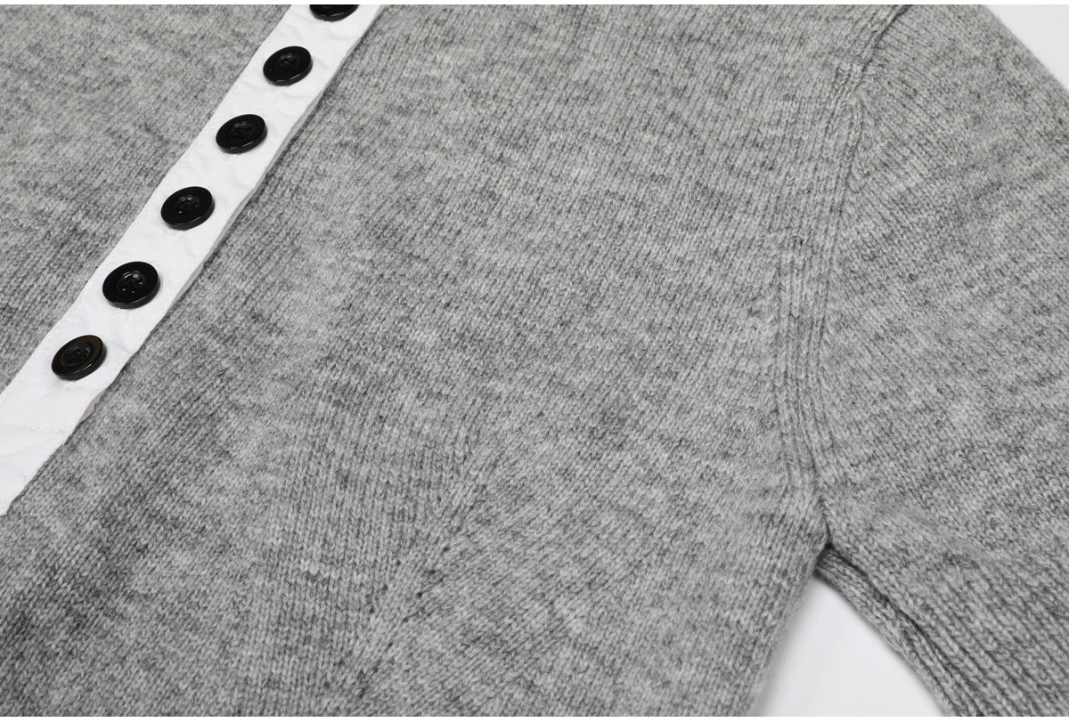 Gray knit top button placket and sleeve seam detail