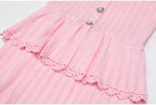 Pink peplum waist and lace trim detail of dress