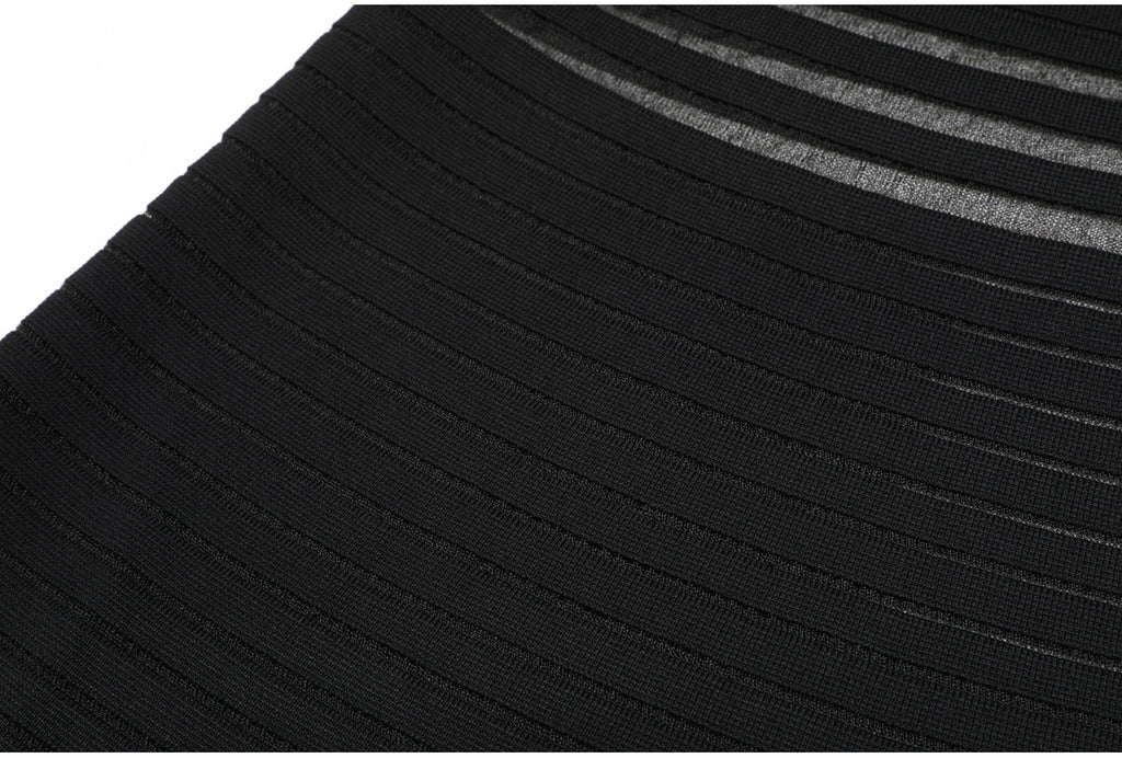Lower skirt detail of black striped knit dress fabric