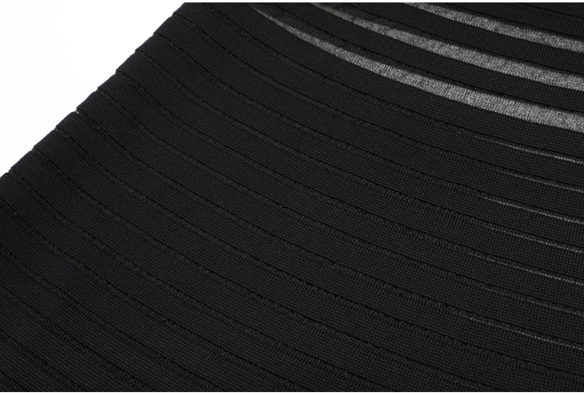 Lower skirt detail of black striped knit dress fabric