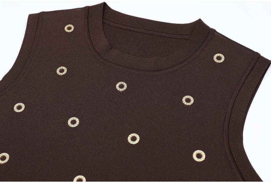 Close-up on brown knit tank with gold circular embellishments
