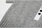 Side view of gray knit top with button placket