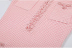 Neckline detail with pearls on pink textured knit dress