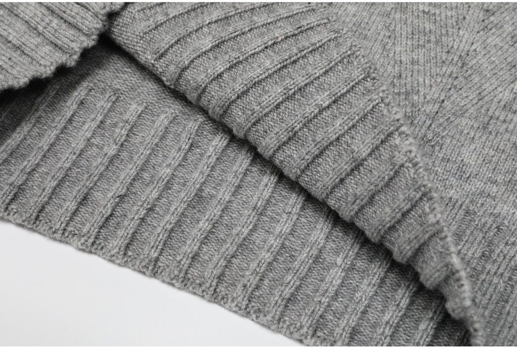 Folded ribbed edge of gray knit sweater