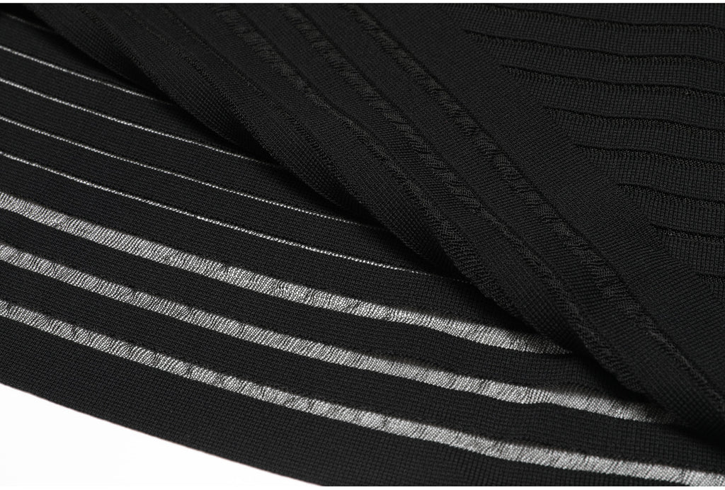 Hem and fabric fold detail of black striped knit dress
