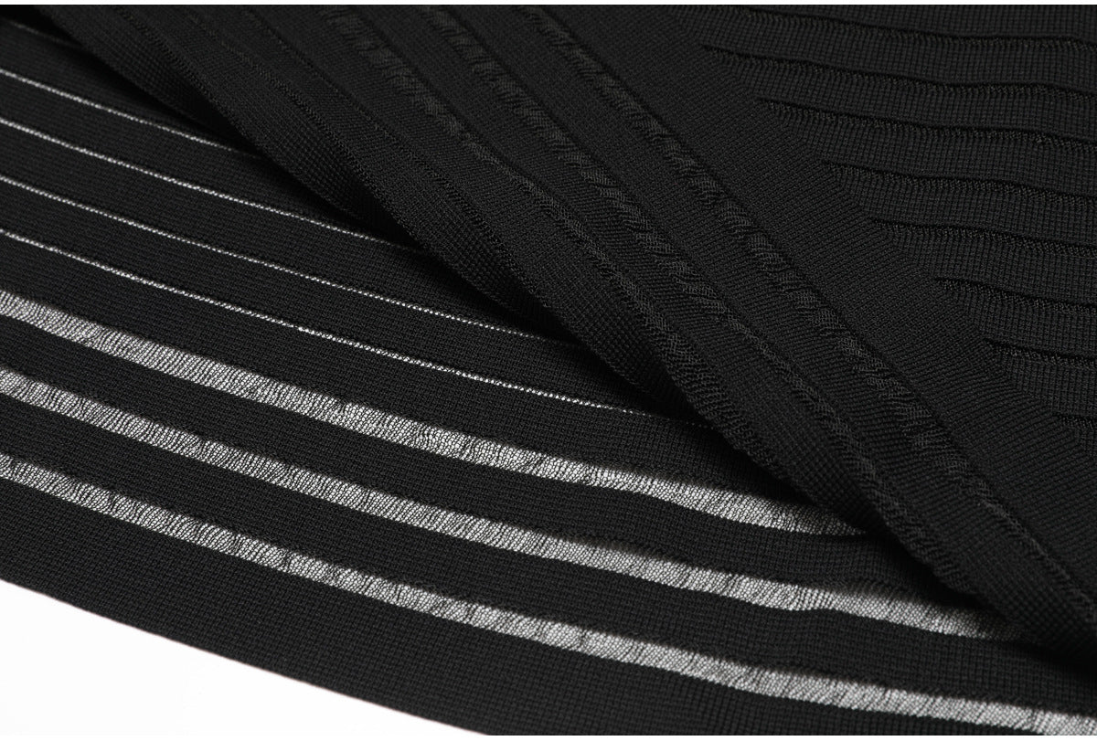 Hem and fabric fold detail of black striped knit dress