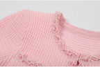 Neckline and placket pearl embellishment close-up on pink dress