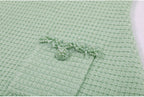 Close-up of mint green dress pocket with pearl embellishments