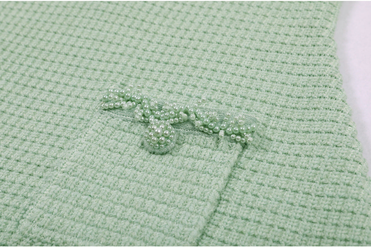 Close-up of mint green dress pocket with pearl embellishments