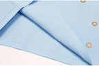 Close-up of blue knit fabric texture and finished edge