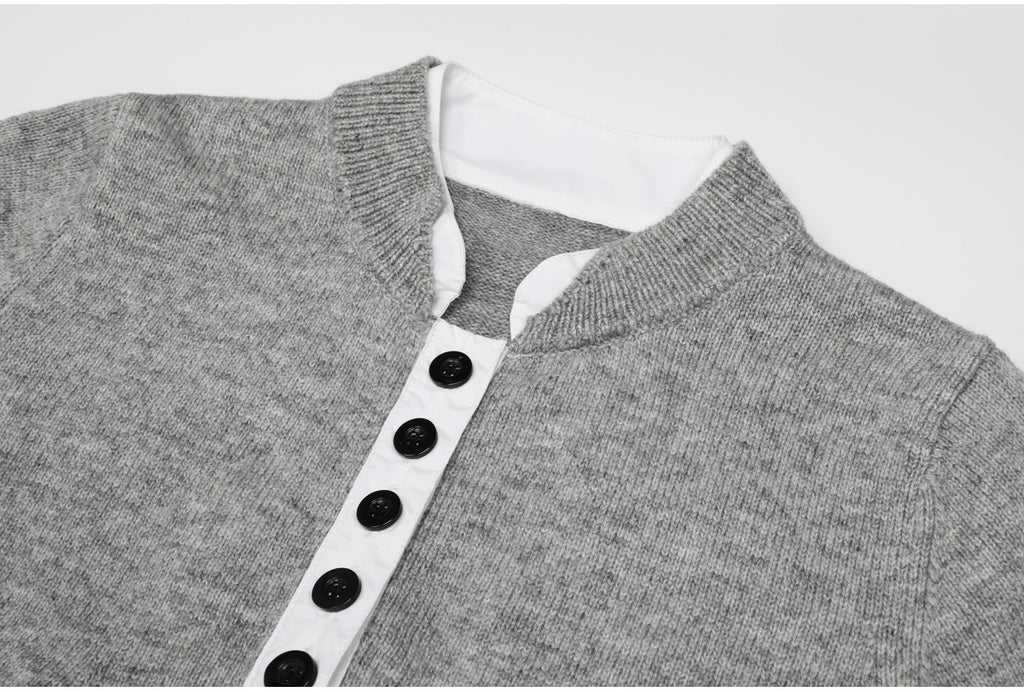Close-up of gray knit top with white button placket