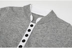Close-up of gray knit top with white button placket