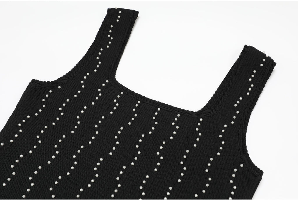 Shoulder and neckline details of black knit dress with pearls
