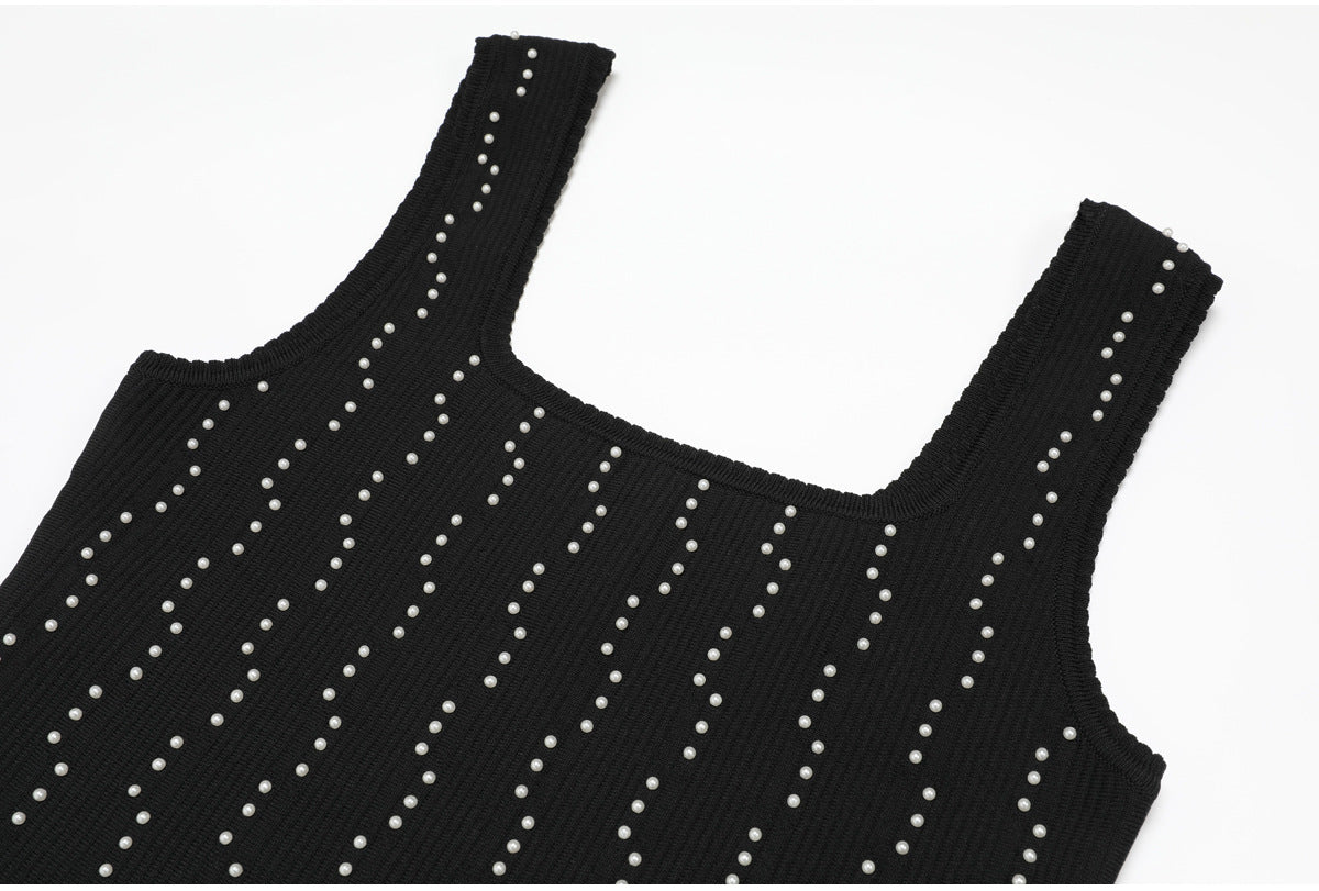 Shoulder and neckline details of black knit dress with pearls