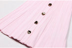 Close-up of pink dress hem with pleats and metallic buttons