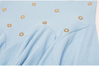 Detail of blue pleated ruffle skirt section with gold embellishments