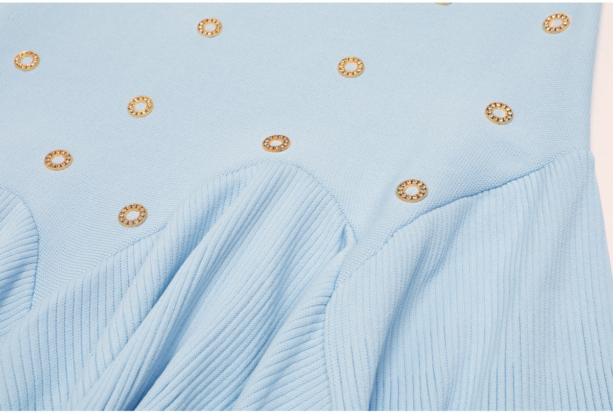 Detail of blue pleated ruffle skirt section with gold embellishments