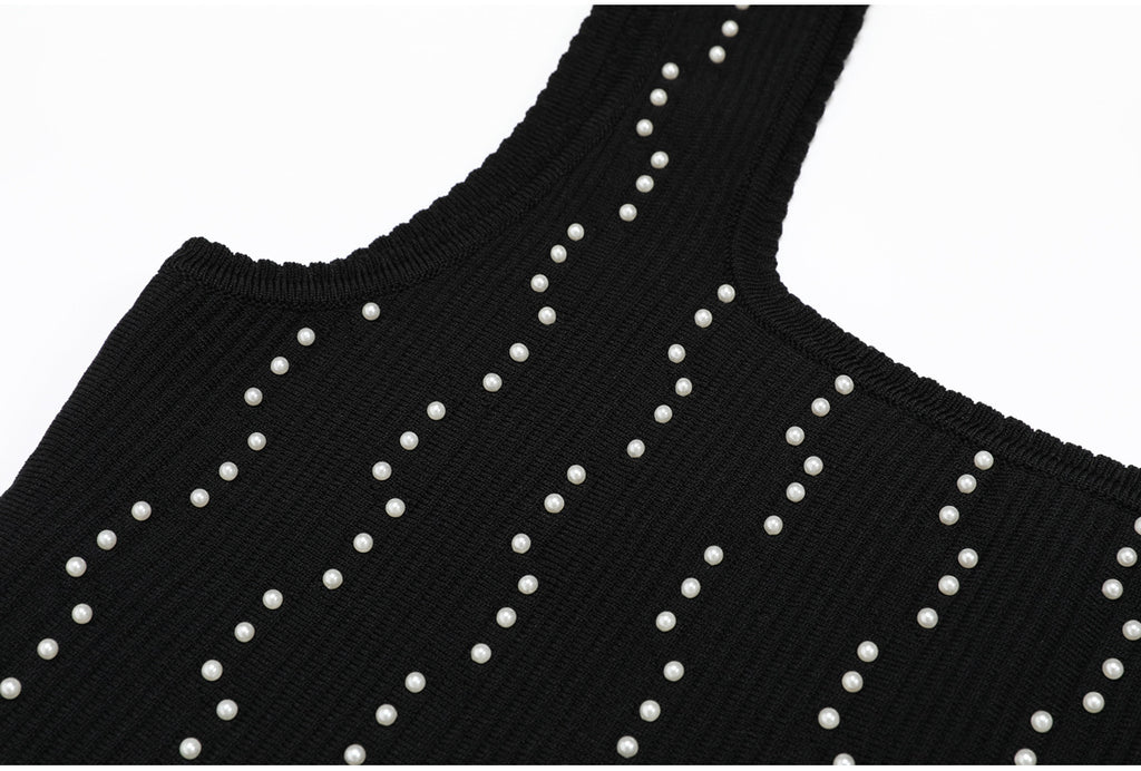 Front view of neckline on black knit dress with pearls