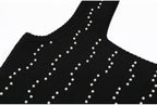 Front view of neckline on black knit dress with pearls