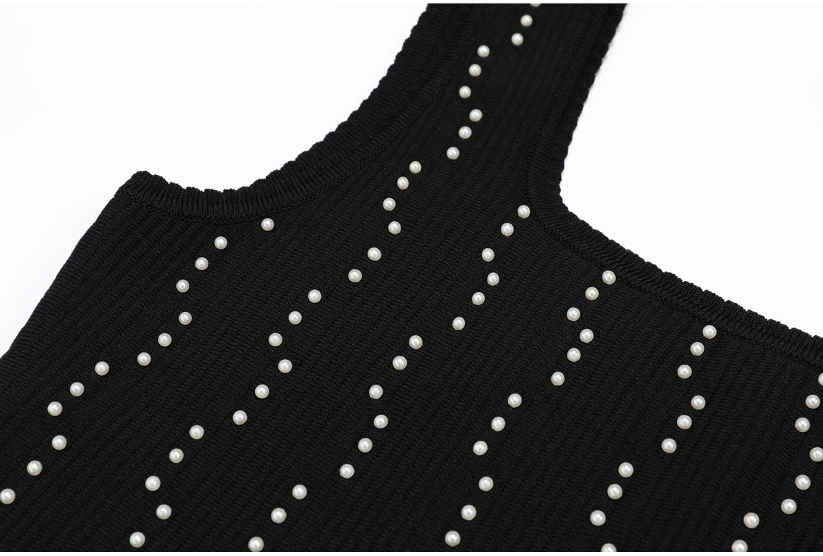 Front view of neckline on black knit dress with pearls