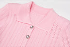 Close-up of pink ribbed collar and pearl buttons on dress