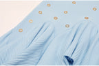 Another close-up on pleated ruffle area and embellishments of blue skirt