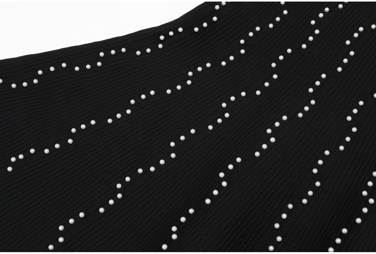 Bottom skirt section of black knit dress with pearl accents
