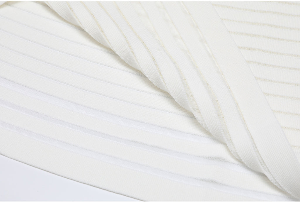 Hem and fabric fold detail of white striped knit dress