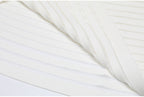Hem and fabric fold detail of white striped knit dress