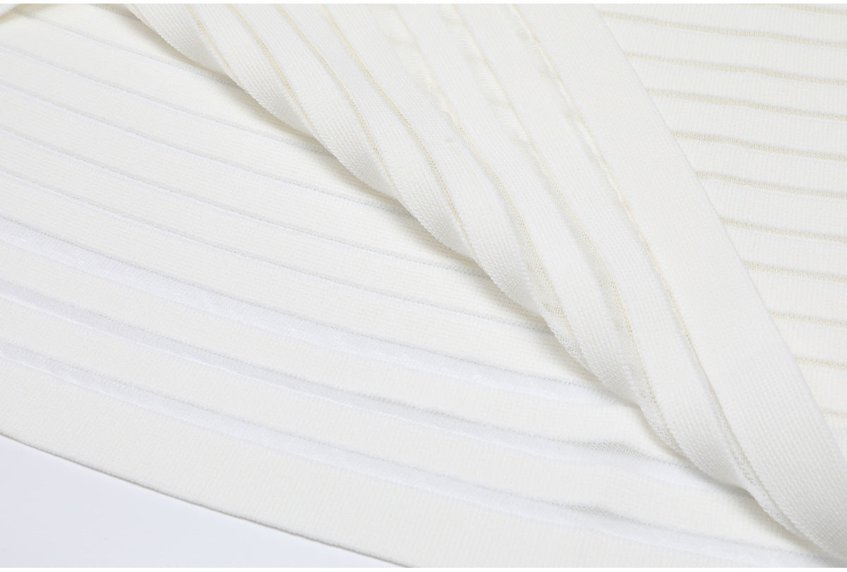Hem and fabric fold detail of white striped knit dress