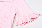 Close-up of ruffled short sleeve on pink dress