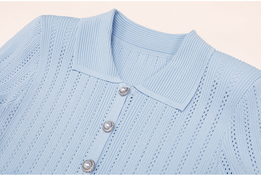 Close-up of blue ribbed collar and pearl buttons on dress
