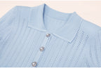 Close-up of blue ribbed collar and pearl buttons on dress