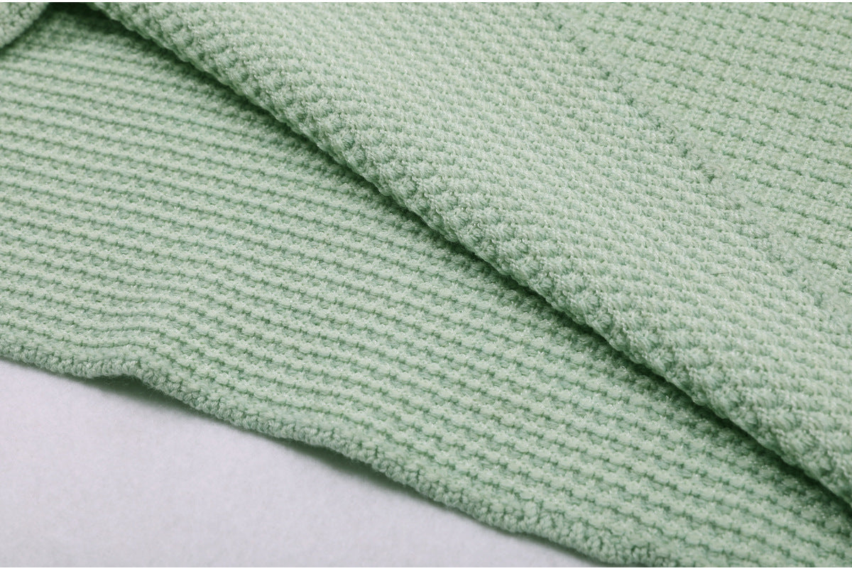 Folded mint green textured knit dress showing fabric quality