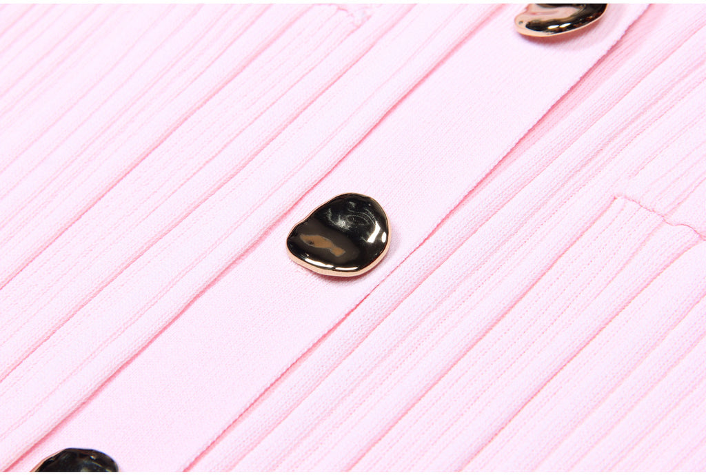 Macro of metallic button on pink dress