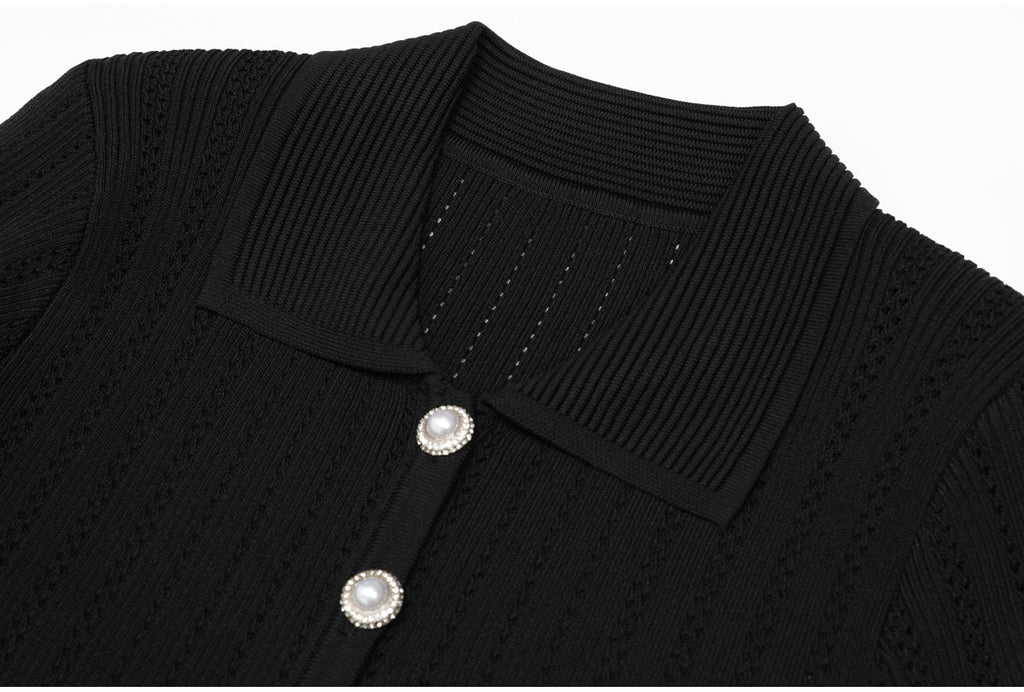 Close-up of black ribbed collar and pearl buttons on dress