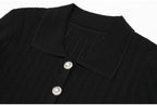 Close-up of black ribbed collar and pearl buttons on dress