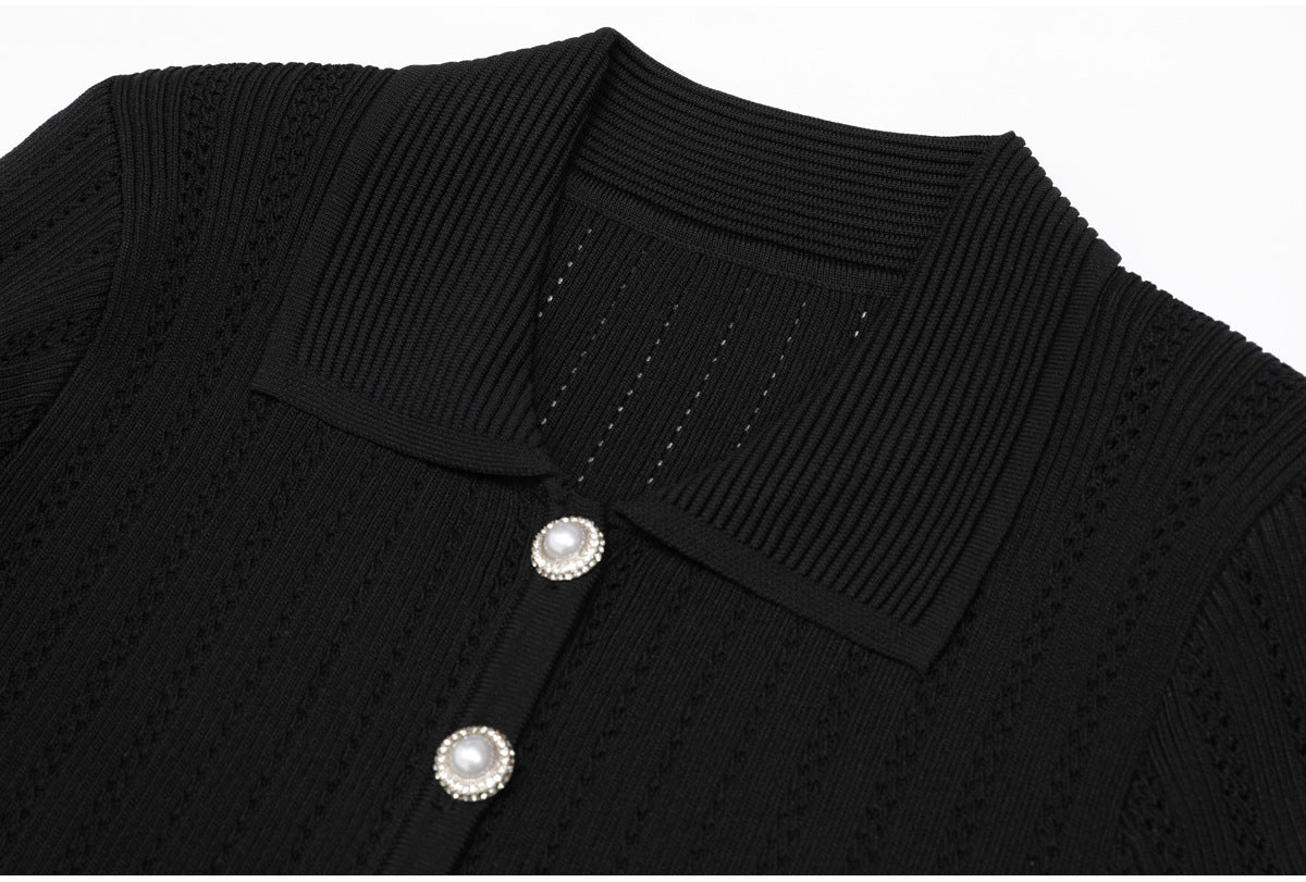 Close-up of black ribbed collar and pearl buttons on dress