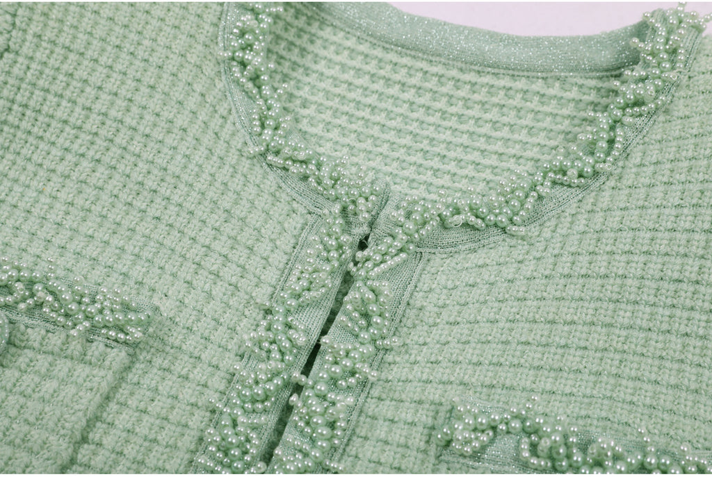 Folded mint green textured knit dress fabric texture