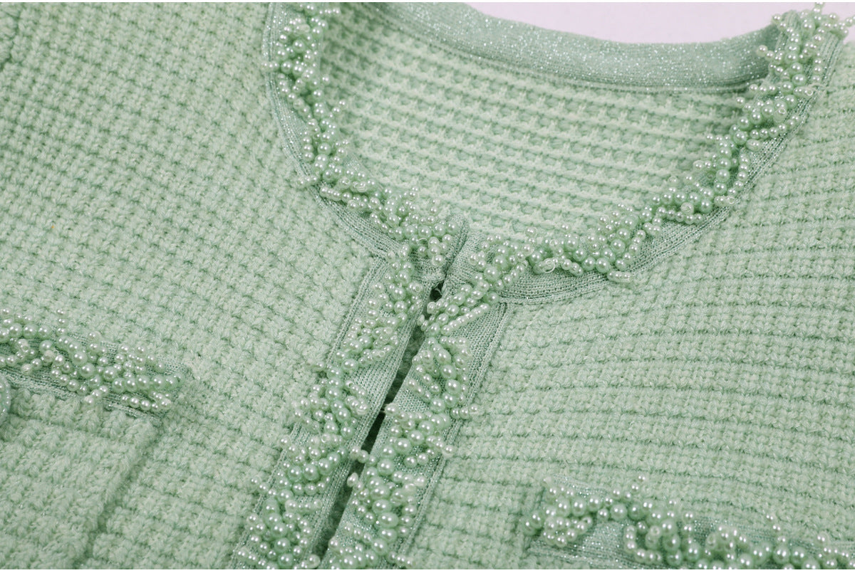 Folded mint green textured knit dress fabric texture