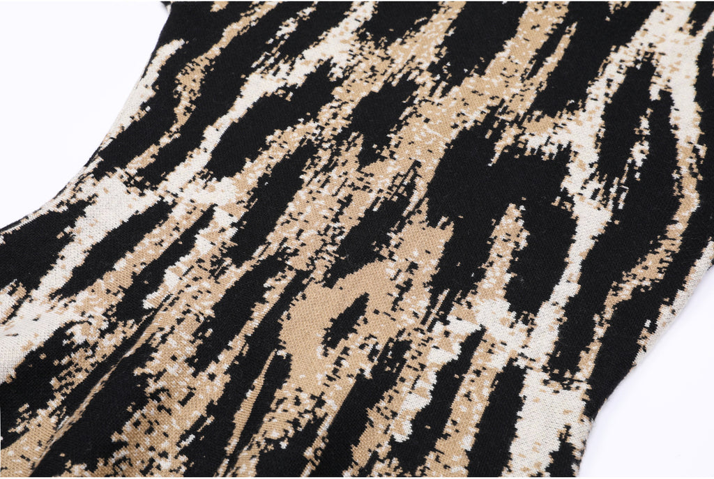 Fabric close-up showing abstract jacquard knit pattern