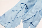 Detailed lower view of pleated blue skirt ruffles